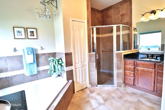 bathroom with tile patterned flooring, plus walk in shower, and vanity