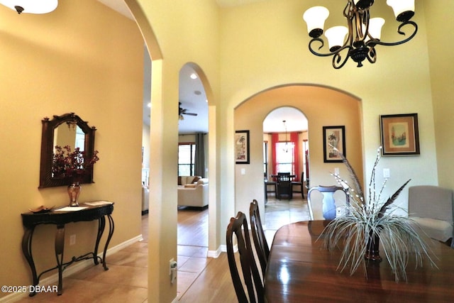 tiled dining room featuring an inviting chandelier