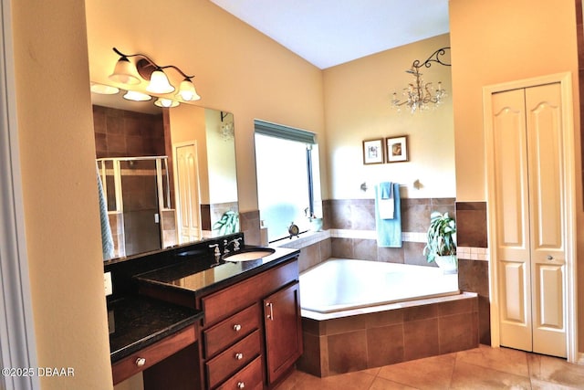 bathroom with tile patterned flooring, vanity, and plus walk in shower