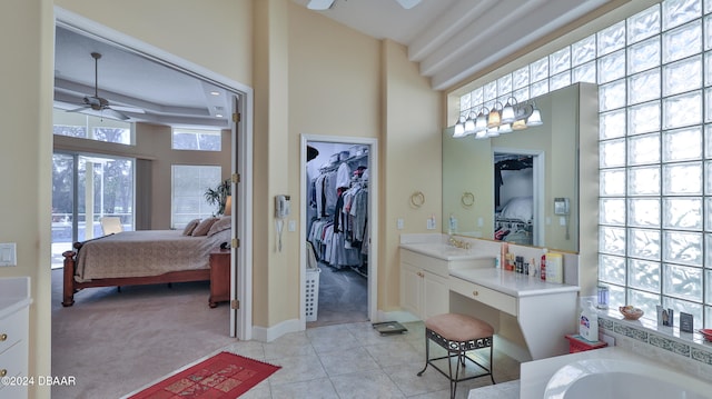 bathroom with vanity, ceiling fan, tile patterned flooring, and a bathtub