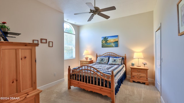 bedroom with light carpet and ceiling fan