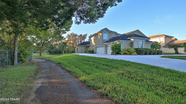 view of front of property featuring a garage and a front yard