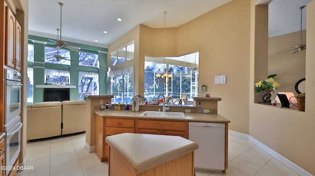 kitchen featuring dishwasher, plenty of natural light, sink, and a center island