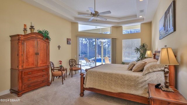 bedroom featuring access to outside, multiple windows, light carpet, and ceiling fan