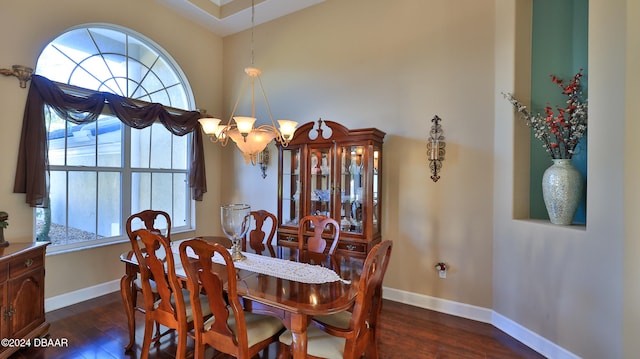 dining room featuring dark wood-type flooring and a chandelier