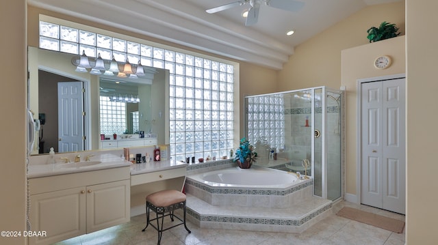 bathroom featuring plus walk in shower, vanity, vaulted ceiling, and tile patterned flooring