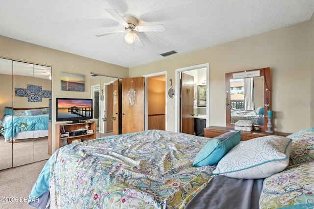 3333 S Ridgewood Ave Unit 8B, Port Orange, FL 32129 - bedroom with two closets, carpet floors, ceiling fan, a textured ceiling, and connected bathroom