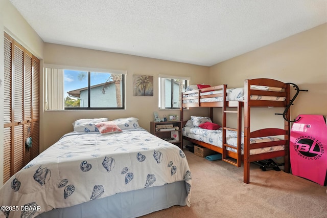 3333 S Ridgewood Ave Unit 8B, Port Orange, FL 32129 - carpeted bedroom with multiple windows, a closet, and a textured ceiling