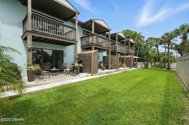 3333 S Ridgewood Ave Unit 8B, Port Orange, FL 32129 - back of house featuring a fenced backyard, a balcony, stucco siding, and a patio area