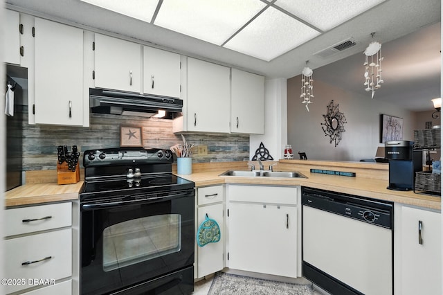 3333 S Ridgewood Ave Unit 8B, Port Orange, FL 32129 - kitchen with white dishwasher, black electric range, extractor fan, light countertops, and backsplash