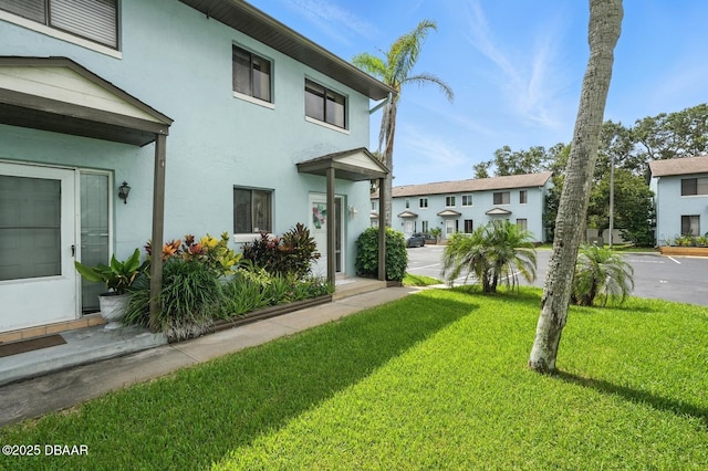 3333 S Ridgewood Ave Unit 8B, Port Orange, FL 32129 - view of front of home with a front yard and stucco siding