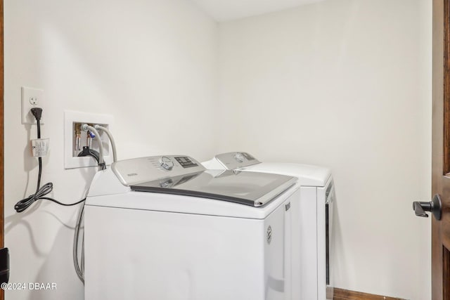 laundry area featuring hardwood / wood-style floors and washer and dryer