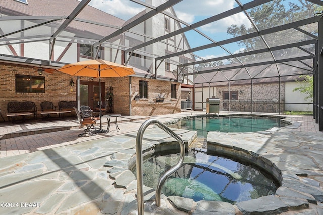 view of pool with a patio, a lanai, and an in ground hot tub