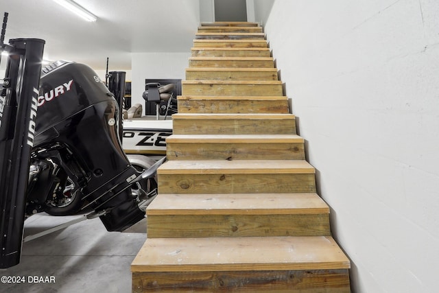 stairway with concrete flooring