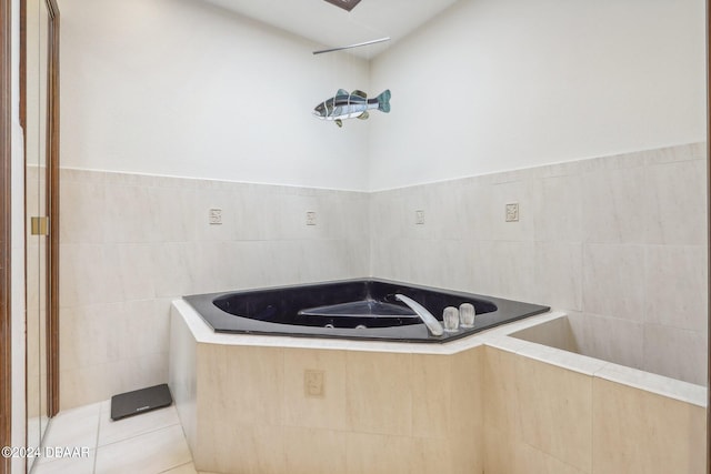 bathroom with a bathtub, tile walls, and tile patterned floors