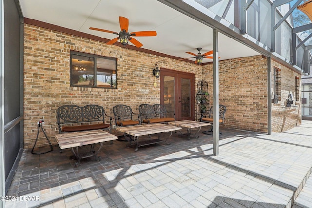 view of patio / terrace featuring ceiling fan, glass enclosure, and french doors