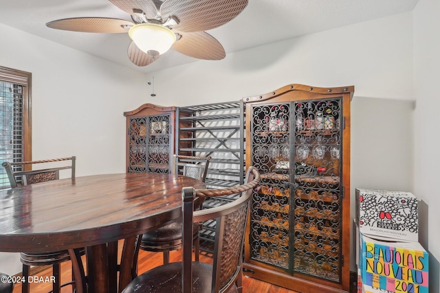 dining area with hardwood / wood-style flooring and ceiling fan