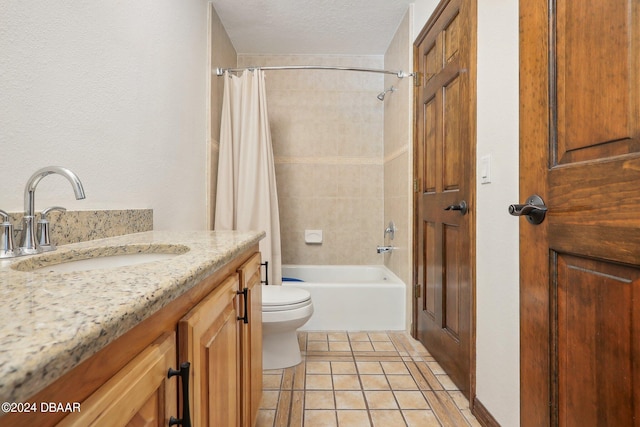 full bathroom featuring shower / bath combination with curtain, vanity, a textured ceiling, tile patterned flooring, and toilet