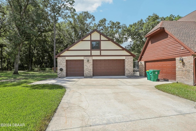 exterior space with a garage, a front yard, and an outdoor structure