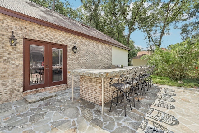 view of patio featuring an outdoor bar and french doors