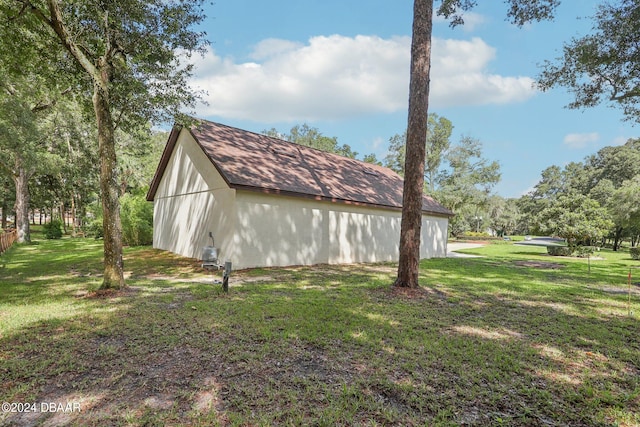 view of property exterior with an outdoor structure and a yard