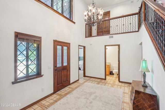 entryway with a notable chandelier and a high ceiling