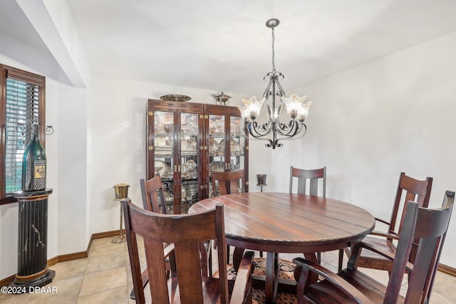 dining area with a chandelier and light tile patterned floors