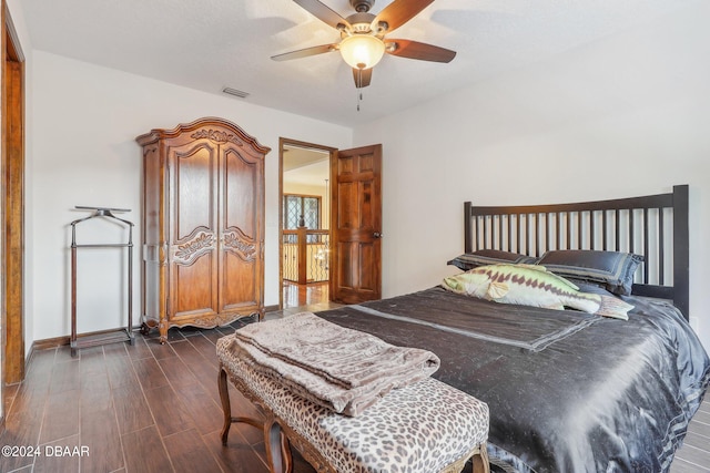 bedroom featuring ceiling fan and dark hardwood / wood-style floors