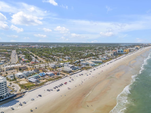 birds eye view of property with a water view, a view of the beach, and a view of city