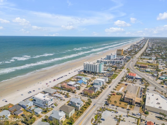 drone / aerial view with a water view and a beach view
