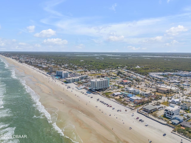 birds eye view of property featuring a water view, a view of city, and a beach view
