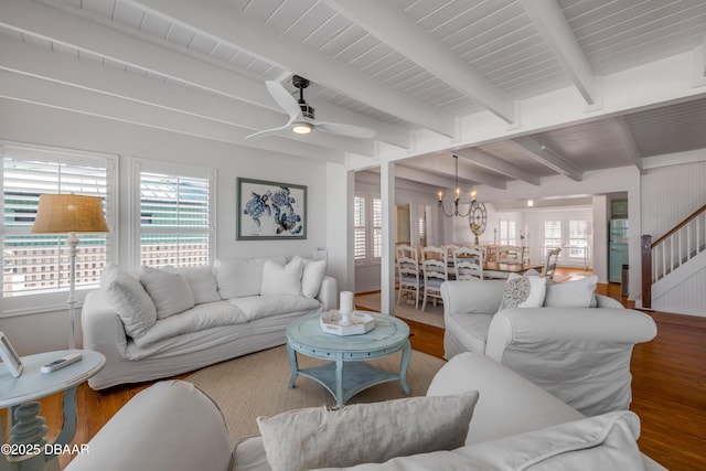 living room with wood finished floors, ceiling fan with notable chandelier, and plenty of natural light