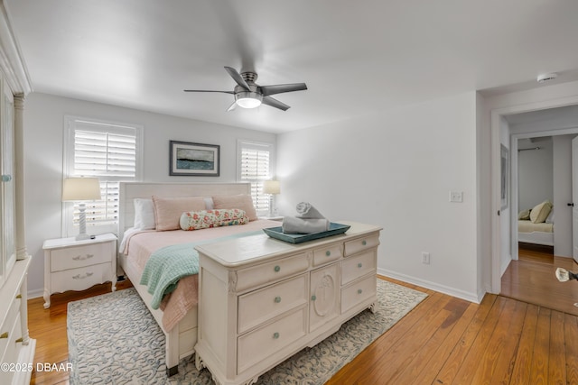 bedroom with baseboards, a ceiling fan, and light wood finished floors