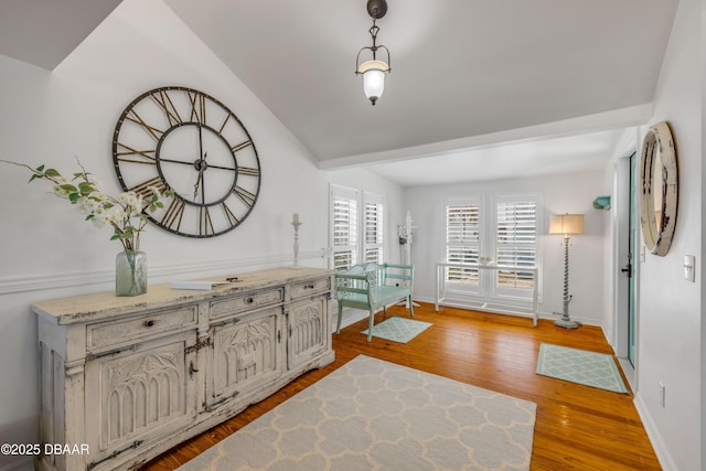 entryway featuring baseboards and wood finished floors