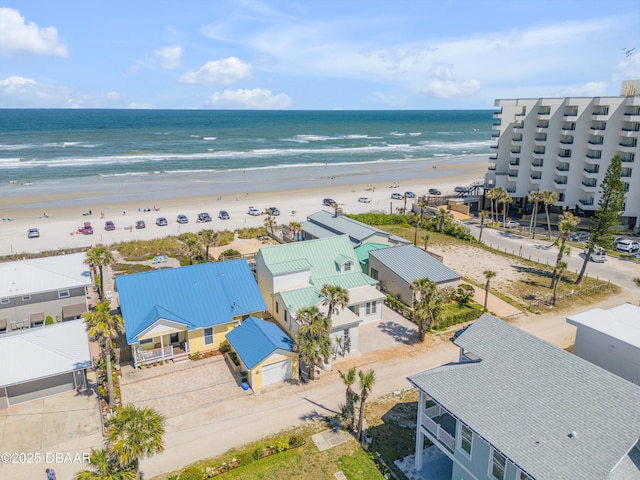 bird's eye view featuring a view of the beach and a water view
