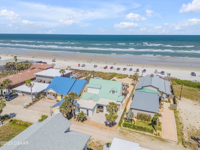 birds eye view of property with a residential view, a water view, and a beach view