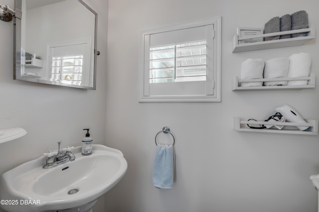 bathroom with a wealth of natural light and a sink
