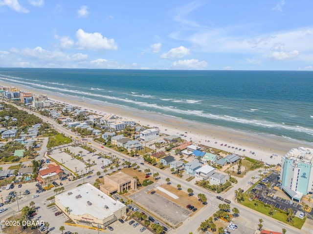 drone / aerial view with a water view and a beach view