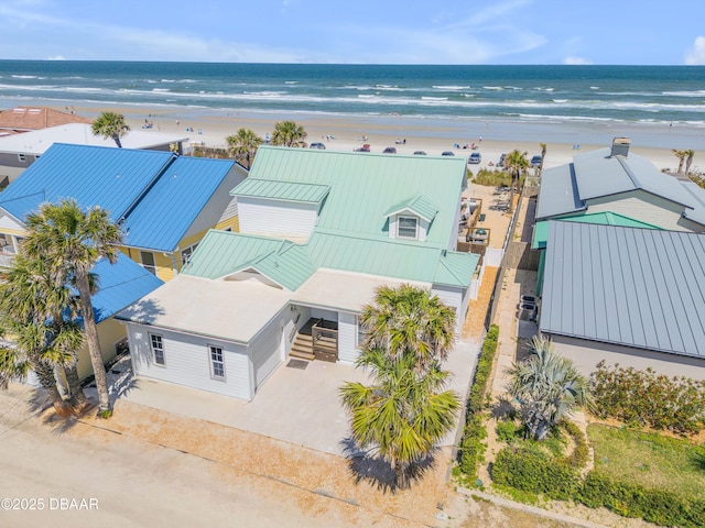 drone / aerial view with a beach view and a water view