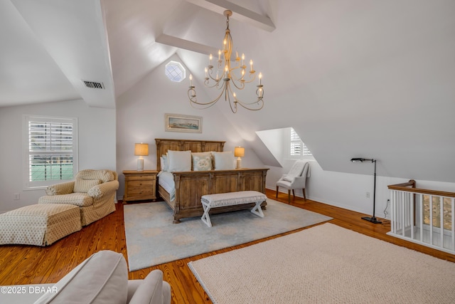 bedroom featuring wood finished floors, a notable chandelier, vaulted ceiling, and visible vents