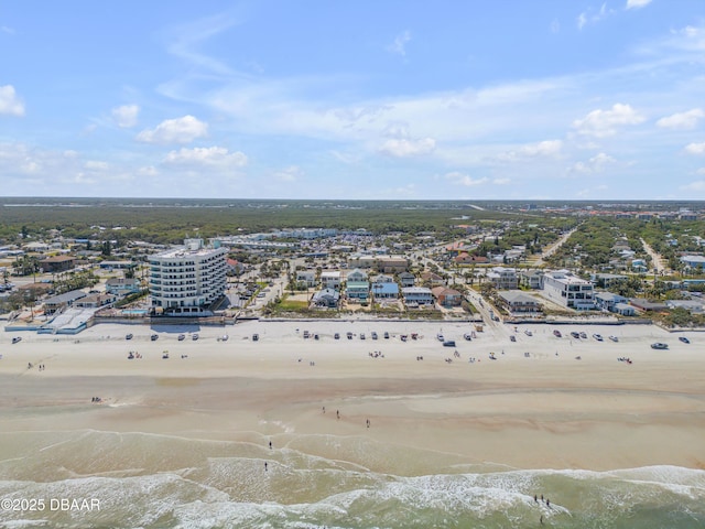 drone / aerial view with a beach view and a water view