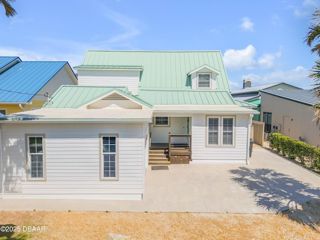 view of front of property featuring covered porch, a standing seam roof, and metal roof