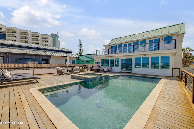 view of pool with outdoor lounge area and a pool with connected hot tub