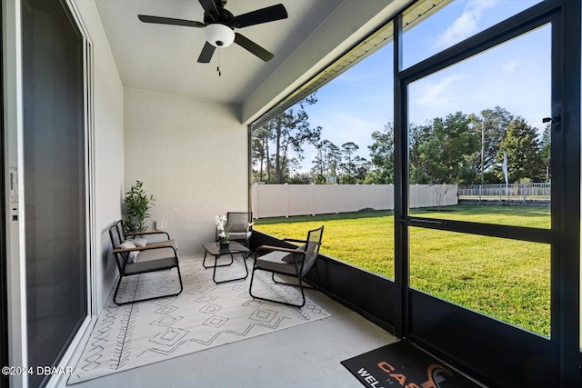 sunroom with ceiling fan and plenty of natural light