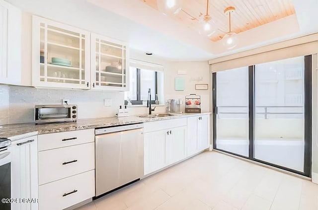 kitchen featuring white cabinetry, sink, light stone counters, decorative light fixtures, and dishwasher