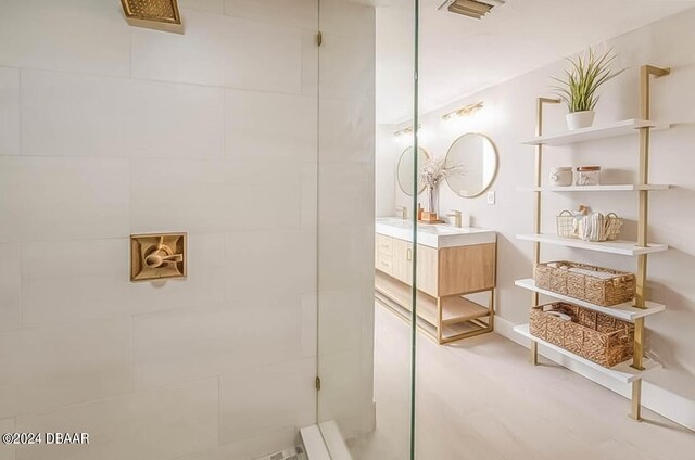 bathroom featuring walk in shower and vanity