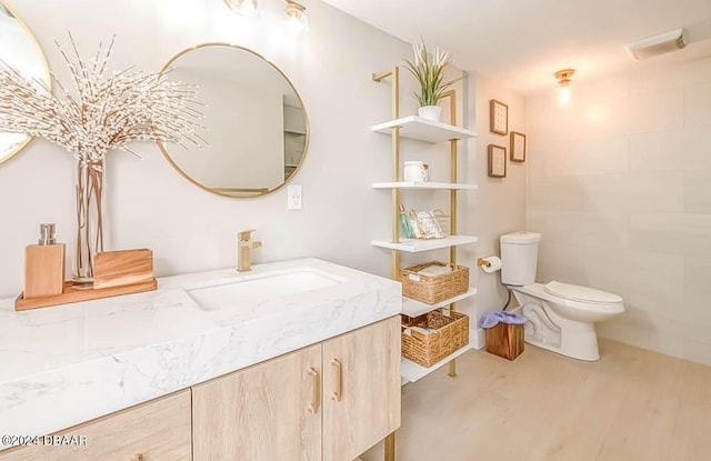 bathroom featuring hardwood / wood-style floors, vanity, and toilet