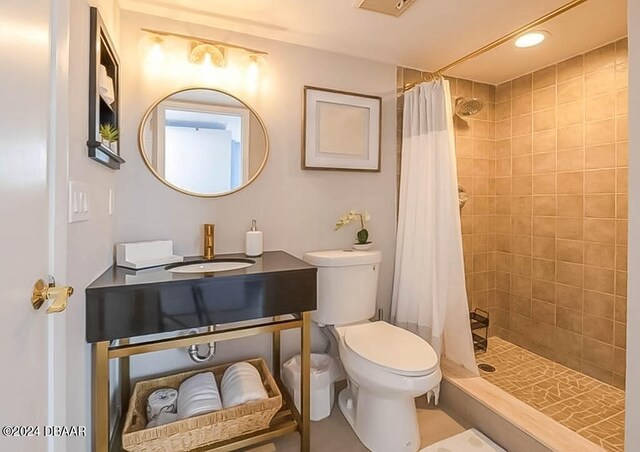 bathroom with sink, toilet, and a shower with curtain