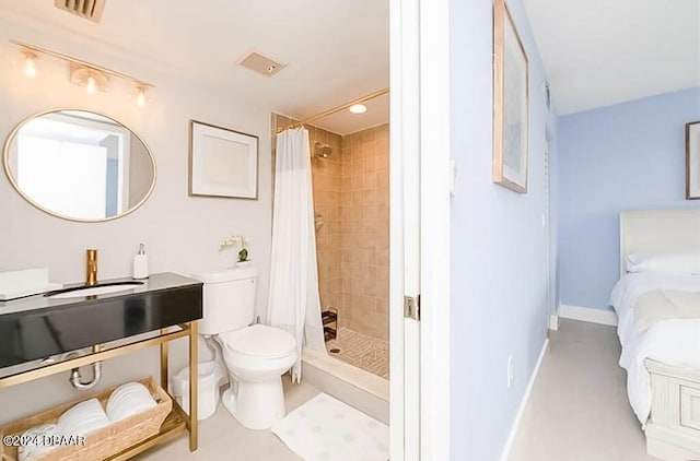 bathroom featuring sink, toilet, and a shower with curtain