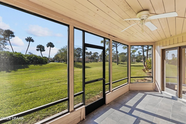 unfurnished sunroom with ceiling fan and wood ceiling